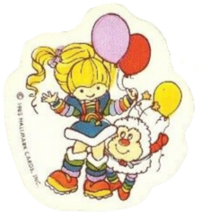 A sticker of Rainbow Brite and Twink holding lavendar, red and yellow balloons.